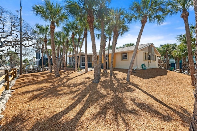 back of property featuring fence and stucco siding