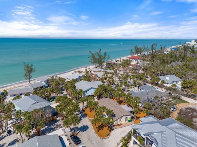 bird's eye view featuring a water view and a beach view