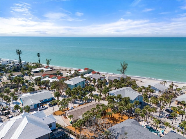 bird's eye view featuring a water view and a beach view