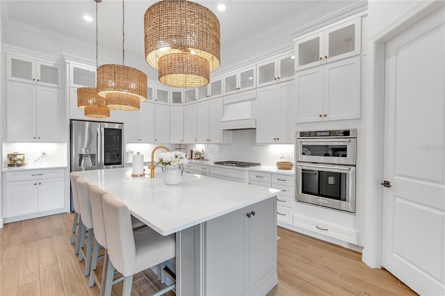 kitchen featuring appliances with stainless steel finishes, custom exhaust hood, decorative backsplash, and crown molding