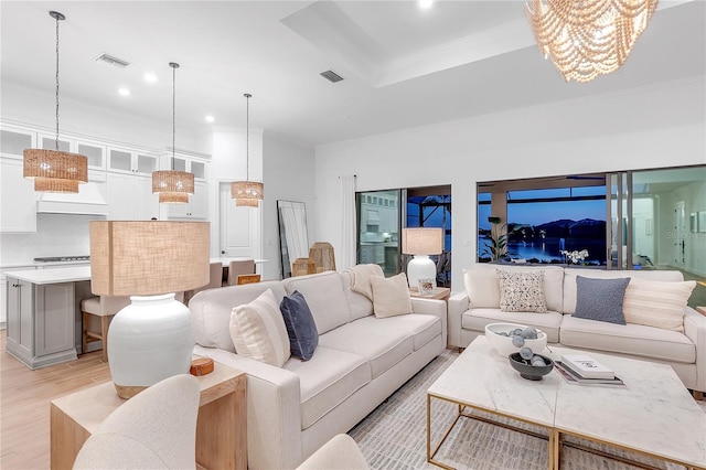 living room with recessed lighting, visible vents, crown molding, and light wood-style flooring