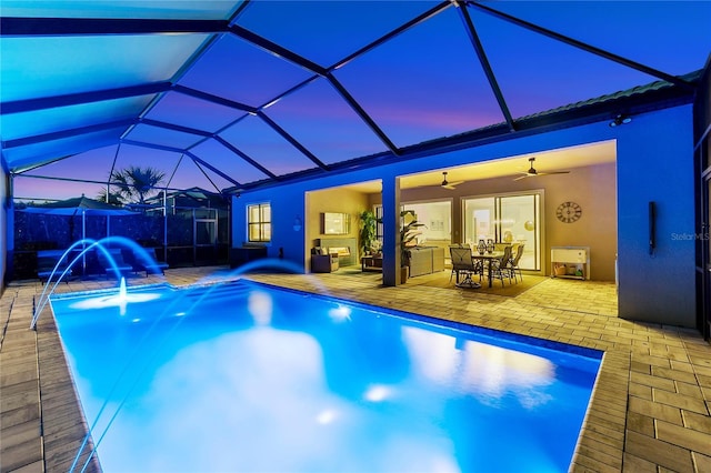 pool at dusk featuring a patio, glass enclosure, and an outdoor pool