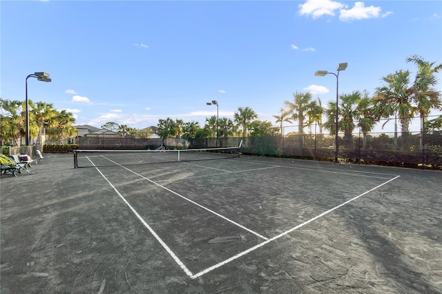 view of tennis court with fence