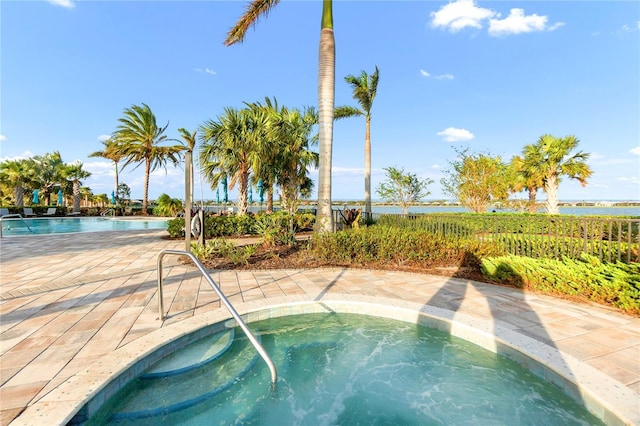 community pool featuring a patio area and a community hot tub