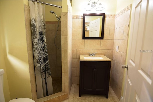 full bath with tile walls, a tile shower, vanity, and toilet