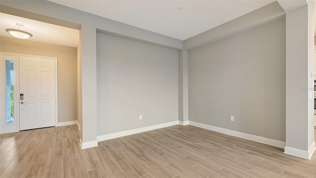 entrance foyer with wood tiled floor and baseboards