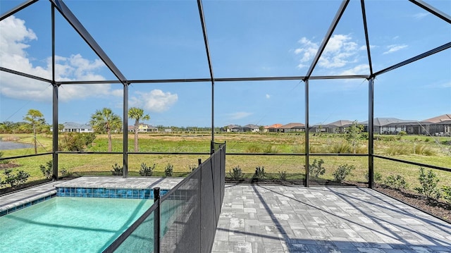 outdoor pool with a lanai and a patio area