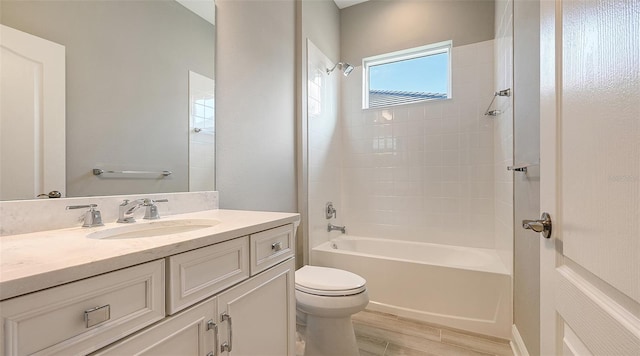 bathroom featuring  shower combination, vanity, toilet, and wood finished floors