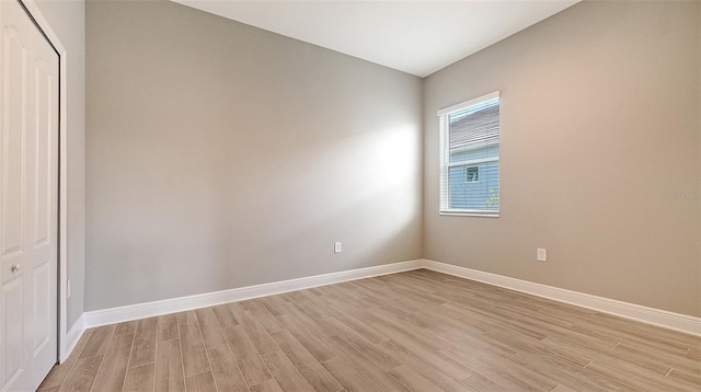 unfurnished room featuring light wood-style flooring and baseboards