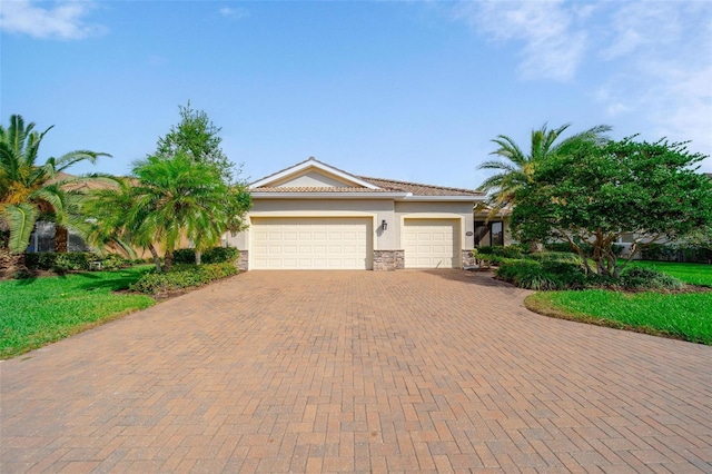 view of front facade with stone siding, decorative driveway, an attached garage, and stucco siding