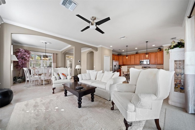 living area featuring light tile patterned floors, visible vents, arched walkways, ceiling fan with notable chandelier, and recessed lighting