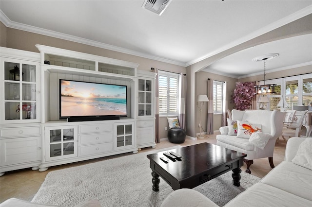 living area featuring light tile patterned floors, visible vents, arched walkways, ornamental molding, and a chandelier