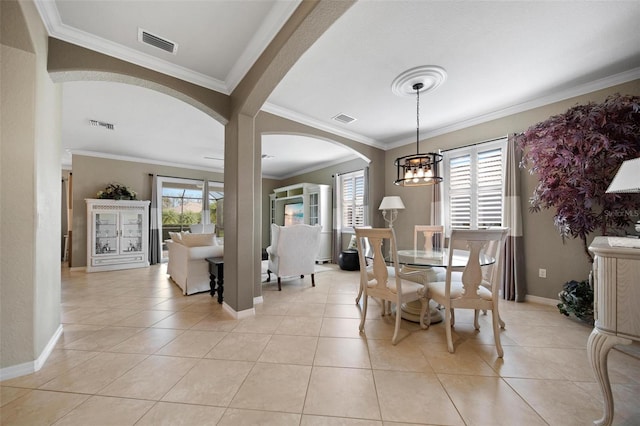 dining space with light tile patterned floors, baseboards, visible vents, and arched walkways