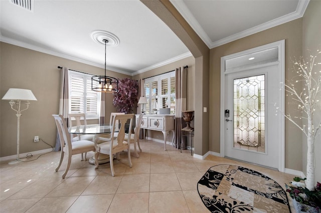 dining room with arched walkways, light tile patterned floors, visible vents, baseboards, and crown molding