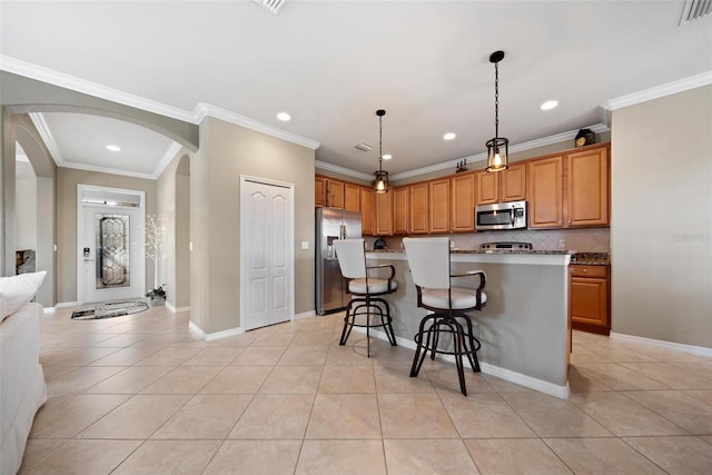 kitchen featuring arched walkways, a breakfast bar, visible vents, appliances with stainless steel finishes, and light tile patterned flooring