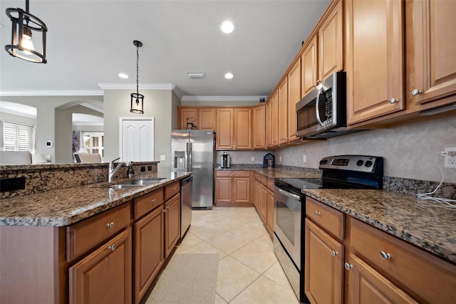 kitchen featuring a sink, visible vents, appliances with stainless steel finishes, backsplash, and dark stone counters