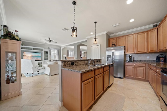 kitchen with arched walkways, light tile patterned floors, stainless steel appliances, a sink, and dark stone counters