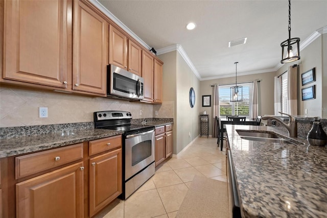 kitchen featuring light tile patterned floors, tasteful backsplash, appliances with stainless steel finishes, crown molding, and a sink