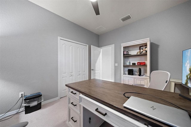 office featuring light carpet, ceiling fan, visible vents, and baseboards