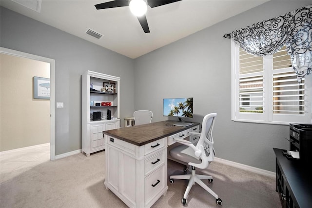 office with baseboards, ceiling fan, visible vents, and light colored carpet