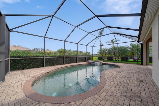 view of swimming pool featuring a pool with connected hot tub, a patio, and a lanai