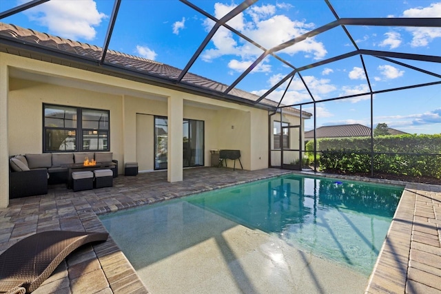 outdoor pool featuring glass enclosure, a patio area, and an outdoor hangout area