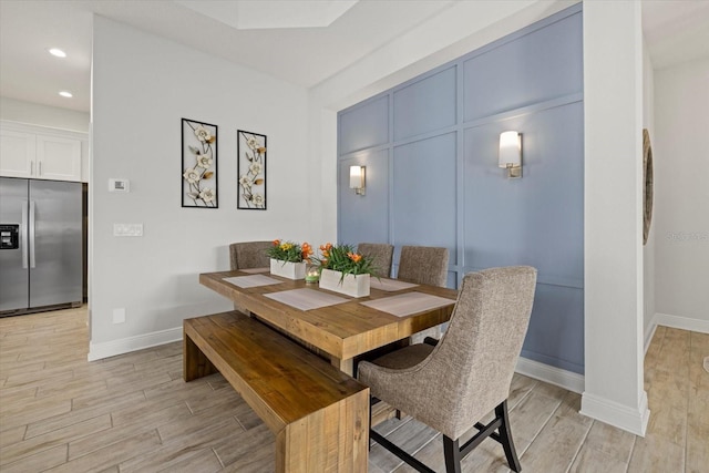 dining space with recessed lighting, baseboards, and wood finish floors