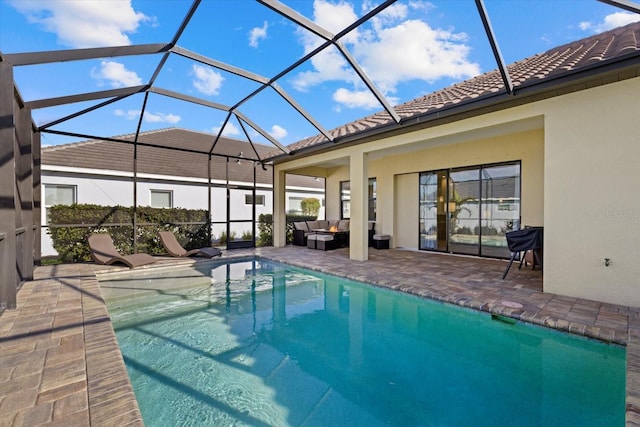 outdoor pool with a lanai, a patio, and an outdoor hangout area