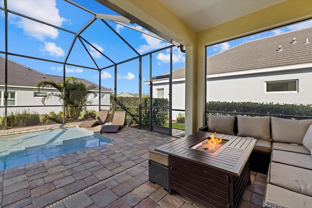 view of patio with a lanai, an outdoor living space with a fire pit, and an outdoor pool