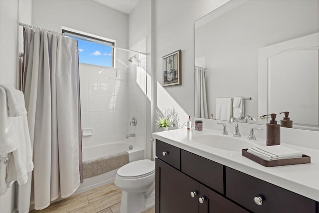 bathroom with wood finished floors, vanity, toilet, and shower / bath combo with shower curtain