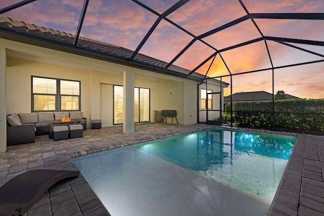 pool featuring a lanai, a patio area, and an outdoor living space