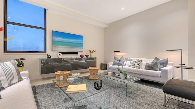 living area with recessed lighting, tile patterned flooring, and baseboards