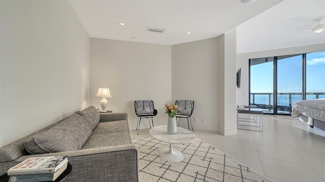 living area with recessed lighting, visible vents, baseboards, and light tile patterned flooring