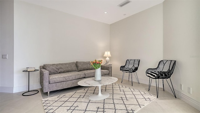 tiled living area with recessed lighting, visible vents, and baseboards