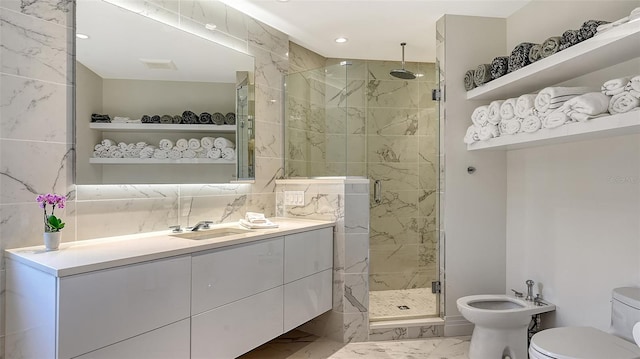 full bathroom with marble finish floor, toilet, a bidet, a shower stall, and vanity