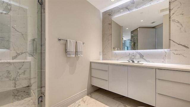 full bath with a marble finish shower, visible vents, marble finish floor, vanity, and recessed lighting