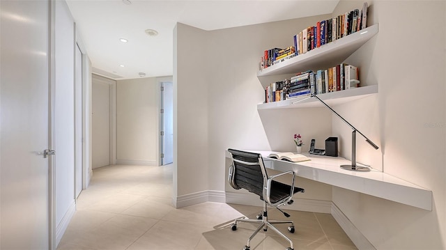 office space with light tile patterned floors, built in desk, recessed lighting, and baseboards