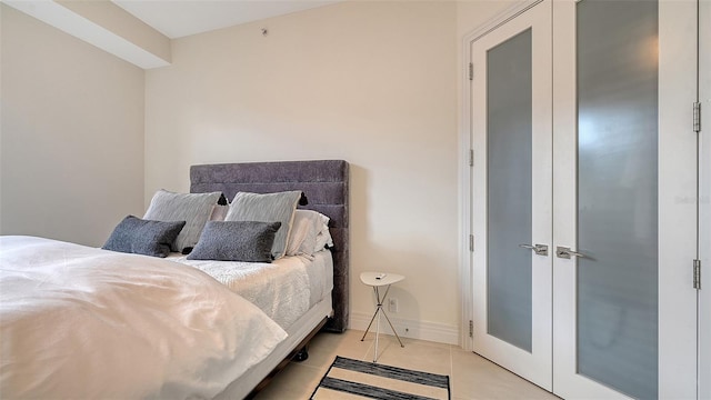 bedroom featuring light tile patterned flooring