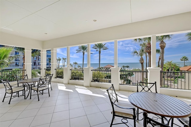 sunroom / solarium with a water view