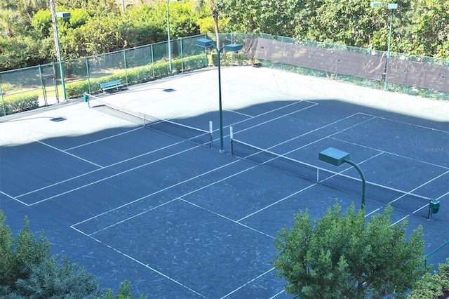 view of tennis court with fence