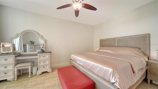 bedroom with baseboards, light tile patterned flooring, and a ceiling fan