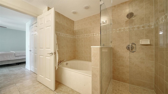 ensuite bathroom with tile patterned floors, connected bathroom, tiled shower, and a bath