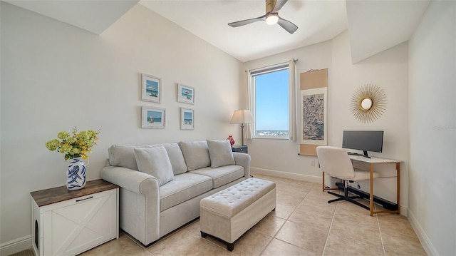 office space featuring baseboards, light tile patterned flooring, and a ceiling fan