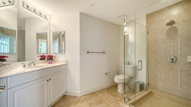 full bathroom with tile patterned floors, toilet, a shower stall, baseboards, and vanity