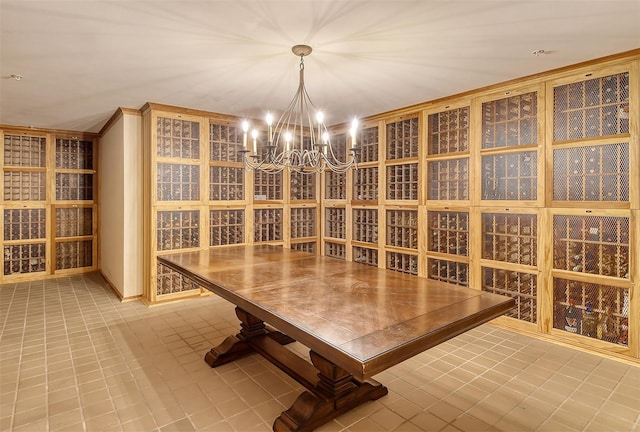 wine cellar featuring tile patterned floors and an inviting chandelier