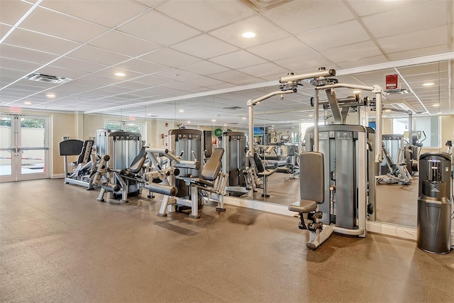 exercise room featuring french doors, visible vents, and a paneled ceiling