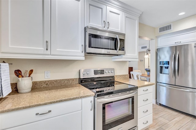 kitchen featuring visible vents, white cabinets, light wood-style flooring, appliances with stainless steel finishes, and recessed lighting