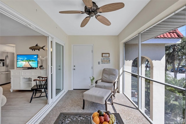 sunroom featuring plenty of natural light, a ceiling fan, and french doors