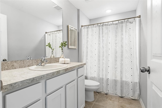 full bathroom featuring a shower with curtain, visible vents, toilet, vanity, and tile patterned flooring