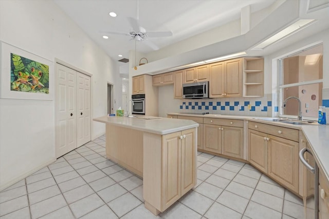 kitchen with light tile patterned flooring, stainless steel appliances, a sink, and light brown cabinetry